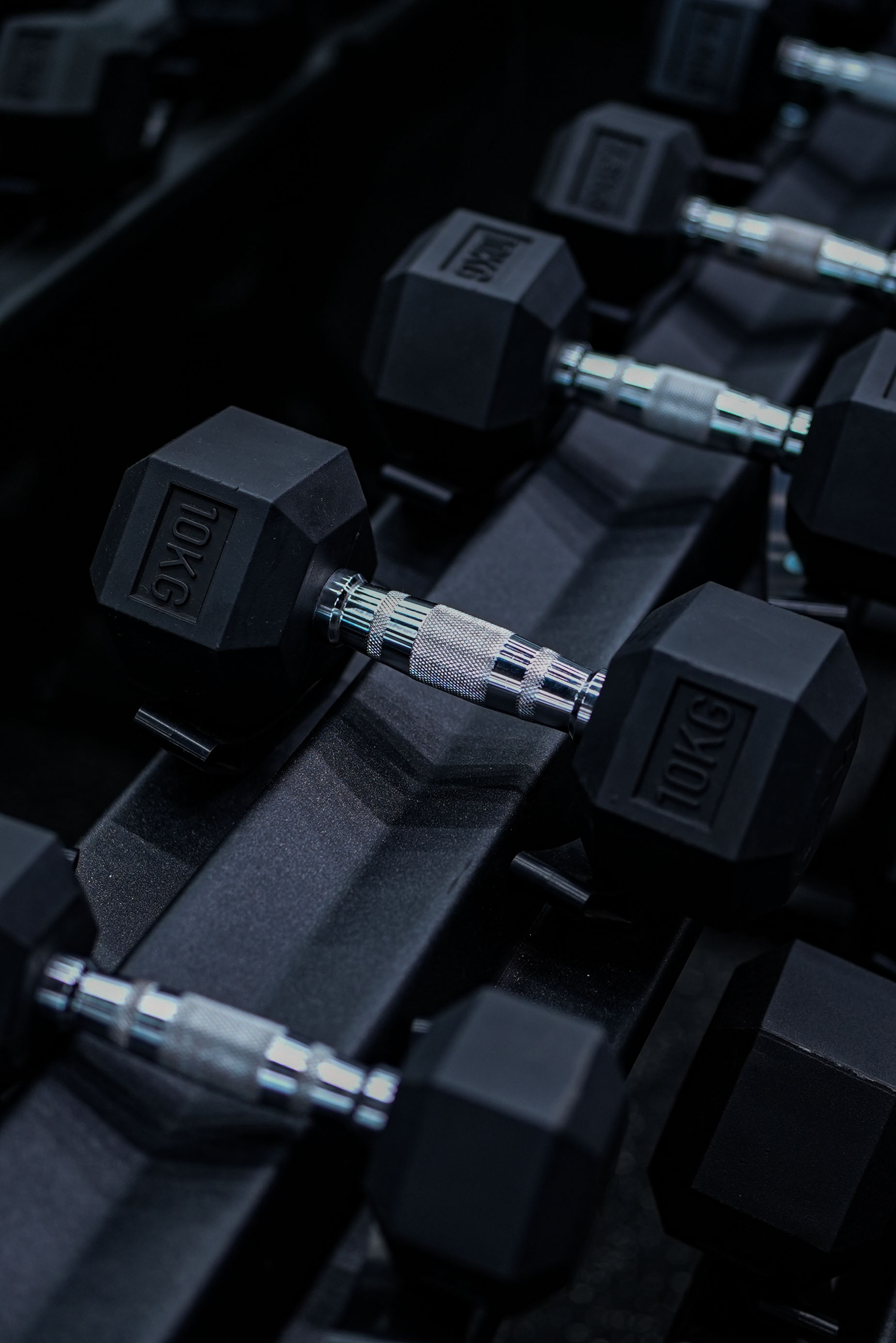 Rack of hex dumbbells on the RAW studio floor